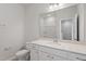 Well-lit bathroom featuring a large mirror, vanity with storage, and tile flooring at 144 Fideaux Blvd # 251, Raleigh, NC 27603