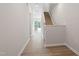 Entryway showcasing hardwood floors leading to a modern kitchen, and stairs with carpet at 144 Fideaux Blvd # 251, Raleigh, NC 27603