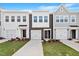 New construction townhome showcasing a modern facade, attached garages, and manicured lawns at 144 Fideaux Blvd # 251, Raleigh, NC 27603