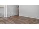 Hallway view featuring wood-look flooring, neutral paint, and a white interior door with hardware at 144 Fideaux Blvd # 251, Raleigh, NC 27603