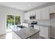 Bright kitchen featuring stainless steel appliances, white cabinets, and granite countertops at 144 Fideaux Blvd # 251, Raleigh, NC 27603