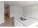 Kitchen island featuring a sink, granite countertops, and stainless steel appliances at 144 Fideaux Blvd # 251, Raleigh, NC 27603