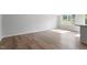 Sun-filled open-concept living room showing hardwood floors, and neutral walls at 144 Fideaux Blvd # 251, Raleigh, NC 27603