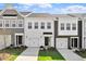 Modern townhome exteriors showcasing stylish designs and well-manicured lawns under a partly cloudy sky at 148 Fideaux Blvd # 250, Raleigh, NC 27603