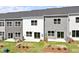 Aerial view of townhome exteriors featuring gray and white siding, and backyard green space at 148 Fideaux Blvd # 250, Raleigh, NC 27603