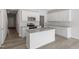 Bright kitchen featuring white cabinets, granite countertops, stainless steel appliances, and an island at 148 Fideaux Blvd # 250, Raleigh, NC 27603