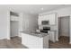 Kitchen featuring an island with sink, granite countertops, white cabinets, and stainless steel appliances at 148 Fideaux Blvd # 250, Raleigh, NC 27603