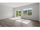 Bright living room with large windows and sliding glass doors offering views of the backyard at 148 Fideaux Blvd # 250, Raleigh, NC 27603