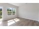 Bedroom with wood flooring, neutral colored walls, large window, and sliding glass door at 152 Fideaux Blvd # 249, Raleigh, NC 27603