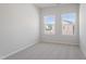 This bedroom has neutral carpeting and two windows for ample natural light at 152 Fideaux Blvd # 249, Raleigh, NC 27603