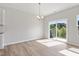 Dining room featuring wood floors, a modern light fixture, and sliding glass door at 152 Fideaux Blvd # 249, Raleigh, NC 27603