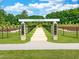 An entry sign welcomes visitors to a manicured dog park at 152 Fideaux Blvd # 249, Raleigh, NC 27603