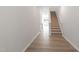 Hallway featuring wood floors, white trim, and stairs to the second level at 152 Fideaux Blvd # 249, Raleigh, NC 27603