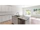 Bright kitchen with stainless dishwasher, granite counters and island with sink and pull out faucet at 152 Fideaux Blvd # 249, Raleigh, NC 27603