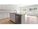 Kitchen with granite countertops, island, stainless steel appliances, and white cabinets at 152 Fideaux Blvd # 249, Raleigh, NC 27603
