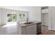 Bright kitchen featuring stainless dishwasher, granite counters and island with sink at 152 Fideaux Blvd # 249, Raleigh, NC 27603