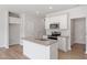 Bright kitchen featuring a granite-topped island with sink, stainless appliances, and modern cabinetry at 152 Fideaux Blvd # 249, Raleigh, NC 27603