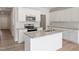 Bright kitchen showcases stainless appliances, granite counters, tiled backsplash, and island with sink at 152 Fideaux Blvd # 249, Raleigh, NC 27603