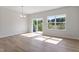 Living room with wood floors and window with outside view at 152 Fideaux Blvd # 249, Raleigh, NC 27603