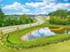A serene pond sits amid lush landscaping and fencing, offering a tranquil view in the neighborhood at 152 Fideaux Blvd # 249, Raleigh, NC 27603