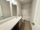 Bathroom with long countertop, large mirror, and bath and shower with sliding doors at 154 Vega Loop, Sanford, NC 27330