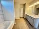 Bathroom featuring double vanity, stylish wood look tile, and a shower/tub combo at 154 Vega Loop, Sanford, NC 27330