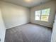 Neutral bedroom has a large window with a view of the outdoors at 154 Vega Loop, Sanford, NC 27330