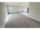 Spacious bedroom with plush carpeting and natural light streaming through two large windows at 154 Vega Loop, Sanford, NC 27330