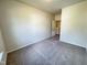 Carpeted bedroom with neutral walls and doorway to walk-in closet at 154 Vega Loop, Sanford, NC 27330