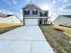 Charming two-story home with gray siding, black shutters, and a long driveway at 154 Vega Loop, Sanford, NC 27330