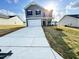 Sunlit front exterior shows a two-story home with an attached garage at 154 Vega Loop, Sanford, NC 27330
