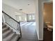 Hallway showcasing wood floors, stairs, and a half bathroom at 154 Vega Loop, Sanford, NC 27330