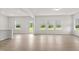 Bright living room featuring many windows offering a view of the outdoors and light colored hardwood flooring at 154 Vega Loop, Sanford, NC 27330