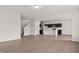 Open floor plan featuring a view of the kitchen with dark cabinets, stainless steel appliances, and an island at 154 Vega Loop, Sanford, NC 27330