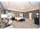 Luxurious main bedroom with tray ceilings, a sitting area, neutral decor, and lots of natural light at 154 Vega Loop, Sanford, NC 27330