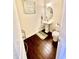 Updated powder room with pedestal sink and dark hardwood floors at 1936 Sinclair Trce, Burlington, NC 27215