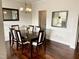 Formal dining room with dark wood table and chairs, hardwood floors and chandelier at 1936 Sinclair Trce, Burlington, NC 27215