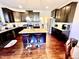 Kitchen with dark cabinets, granite countertops and an island at 1936 Sinclair Trce, Burlington, NC 27215