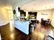 Modern kitchen with dark cabinetry, breakfast bar, and hardwood floors at 1936 Sinclair Trce, Burlington, NC 27215