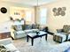 Living room with neutral colored couches and hardwood floors at 1936 Sinclair Trce, Burlington, NC 27215