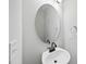 Simple bathroom with oval mirror and white sink at 21 Nettle Ln # 252, Clayton, NC 27520