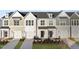 Four townhouses with neutral siding, two-car garages, and landscaping at 21 Nettle Ln # 252, Clayton, NC 27520