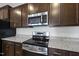 Stainless steel range and microwave in a modern kitchen at 21 Nettle Ln # 252, Clayton, NC 27520