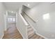 Modern staircase with wood railing and carpeted steps at 21 Nettle Ln # 252, Clayton, NC 27520