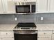 Modern electric cooktop and microwave in kitchen at 2225 Gathering Square Ct # 2225, Fuquay Varina, NC 27526