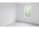 Spacious bedroom with a large window and grey carpet at 272 Sweetbay Tree Dr, Wendell, NC 27591