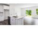 Modern kitchen with white cabinets, quartz countertops, and island at 272 Sweetbay Tree Dr, Wendell, NC 27591
