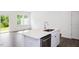 Modern kitchen with white cabinets, quartz countertops, and island at 272 Sweetbay Tree Dr, Wendell, NC 27591