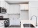 Modern kitchen with white cabinets, quartz countertops, and island at 272 Sweetbay Tree Dr, Wendell, NC 27591