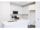 Modern kitchen with white cabinets, quartz countertops, and island at 272 Sweetbay Tree Dr, Wendell, NC 27591